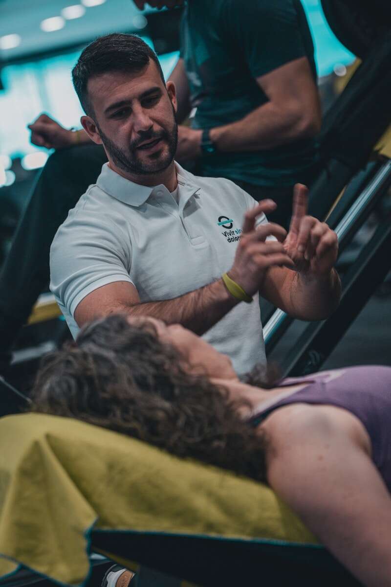 A man sitting in a chair talking to a woman